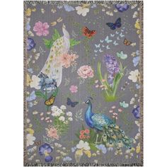 a blanket with flowers, butterflies and a peacock on the front is shown in grey