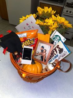 a basket filled with various items sitting on top of a counter next to a flower pot