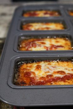 four pans filled with cheese and pepperoni pizza