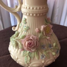 a white vase with flowers painted on it