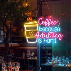 a neon sign that says coffee because adulting is hard