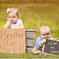 two babies are sitting in crates holding signs that say brother for sale and sister for sale