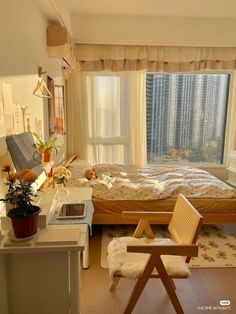 a bedroom with a bed, desk and chair next to a window in the room