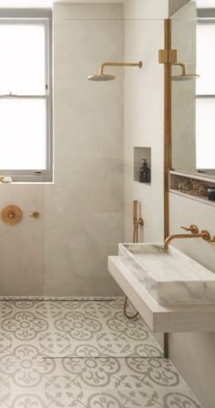 a bathroom with a sink, toilet and shower in it's own area next to a window