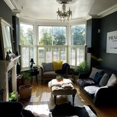 a living room filled with furniture and windows