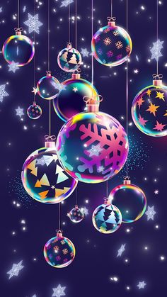 christmas balls and snowflakes hanging from strings on a dark background with stars in the sky