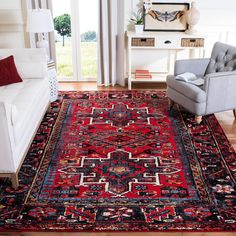 a living room filled with furniture and a red rug