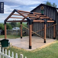 a wooden structure sitting in the middle of a yard