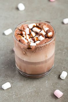 a drink with marshmallows in it on a table