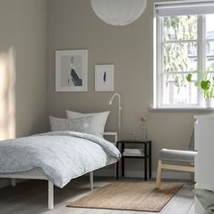 a bedroom with a bed, chair and window