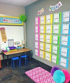 an office decorated in bright colors with posters on the wall and colorful pom poms