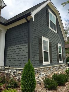 a gray house with white trim and windows