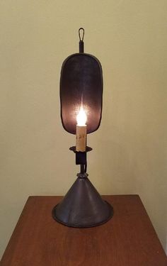 a lit candle on top of a wooden table