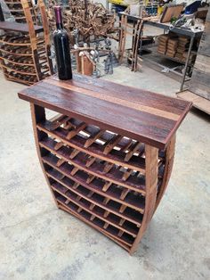 a wine rack made out of wood with a bottle sitting on it's top