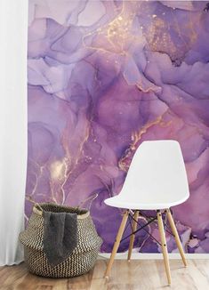 a white chair sitting in front of a wall with purple paint on it's walls