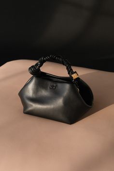 Iconic Handbags Designer Bags, Ganni Bou Bag Outfit, Leau Papier, Ganni Bou Bag, Ganni Bag, Bag Closet, Butterfly Logo, Bag Obsession, Hands Holding