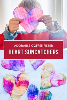 a child holding up paper hearts with the words adorable coffee filter heart suncatchers