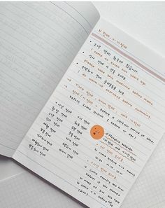 an open notebook with writing on it