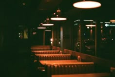 an empty restaurant with tables and chairs in the dark