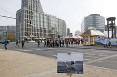 people are walking on the street in front of some buildings