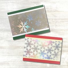 two cards with snowflakes on them sitting next to each other