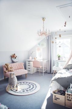 a child's bedroom decorated in pastel colors and white, with pink accents