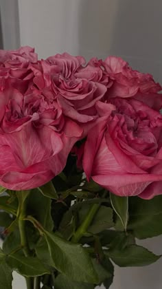 a vase filled with pink flowers on top of a table