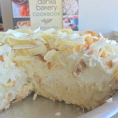 a piece of coconut cream pie on a blue plate