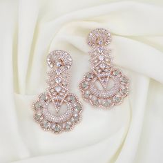 Step out in style this season with these glamorous American Diamond dangler earrings! These dazzling earrings are an ideal accessory to upgrade your look and add a touch of sophistication to any ensemble. Whether you're looking for something elegant for a night out or something more subtle for everyday wear, these American Diamond earrings are sure to make a statement. Approximate earring length is 2.5" Width is 1.5" approx.   Material: Brass  Gemstone: Semi precious Stone American Diamond Earrings, Pink Diamond Earrings, Diamond Danglers, Dazzling Earrings, Dangler Earrings, Gold Plated Bangles, Pakistani Jewelry, Semi Precious Stone, Diamond Drops