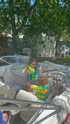 two children in life vests on a boat