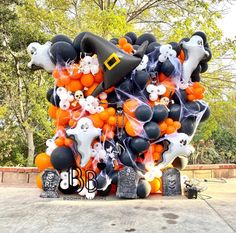 a bunch of balloons that are in the shape of witches and ghost's heads