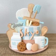 a cake decorated with baking utensils and cookies