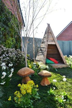 a small wooden shelter sitting in the middle of a garden