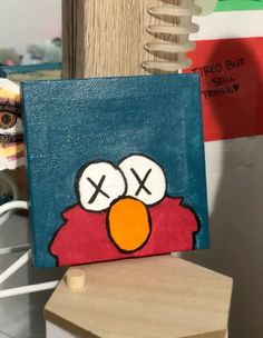 a painting of an angry bird on a wooden block