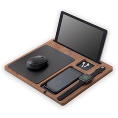 a wooden desk with a laptop, mouse and cell phone on it's tray