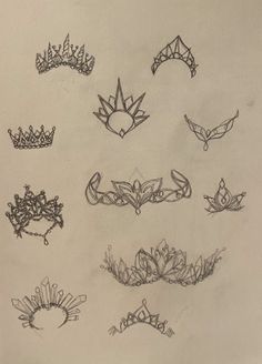 several crowns and tiaras are drawn on paper