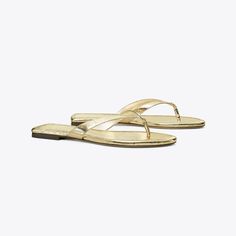 Classic Flip-Flop: Women's Designer Sandals | Tory Burch Gold Sandals With Gold-tone Hardware And Single Toe Strap, Classic Gold Sandals With Single Toe Strap, Gold Cushioned Flip Flops For Vacation, Classic Gold Sandals For Summer, Classic Gold Sandals With Cushioned Footbed, Luxury Gold Sandals With Cushioned Footbed, Gold Cushioned Flip Flops For Spring, Chic Gold Sandals With Textured Footbed, Gold Toe Post Sandals With Cushioned Footbed