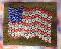 an american flag made out of beer caps on a piece of wood with watercolor paint