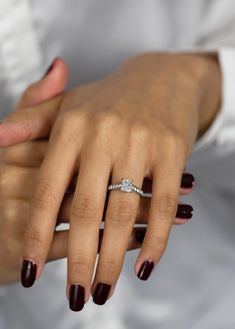 a woman's hand with a diamond ring on it