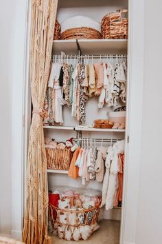 an organized closet with clothes and baskets