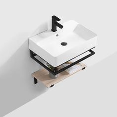 a white sink sitting on top of a wooden shelf