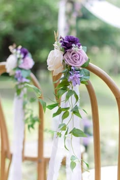 purple and white flowers are on the back of chairs