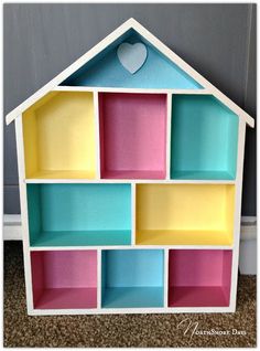 a doll house made out of cardboard blocks with a heart on the top and bottom shelf