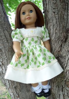 a doll is sitting in the branches of a tree wearing a white dress and black shoes