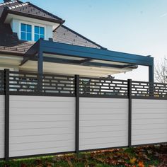 a white and black fence in front of a house