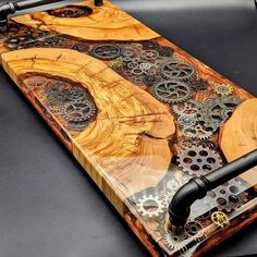 an iphone case made out of wood with gears and wheels on the back, sitting on top of a table