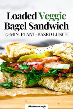 a close up of a sandwhich on a cutting board with the title loaded veggie bagel sandwich