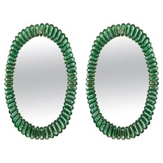 a pair of green beaded mirrors sitting next to each other