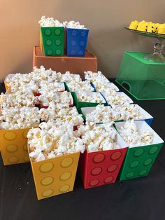 lego blocks are stacked on top of each other with popcorn in the middle and one block is made out of legos