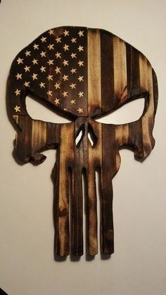 a skull with an american flag painted on it's face is hanging from the wall